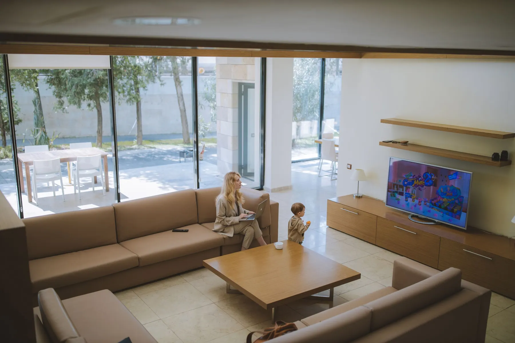 Bright living room with a television on a cabinet